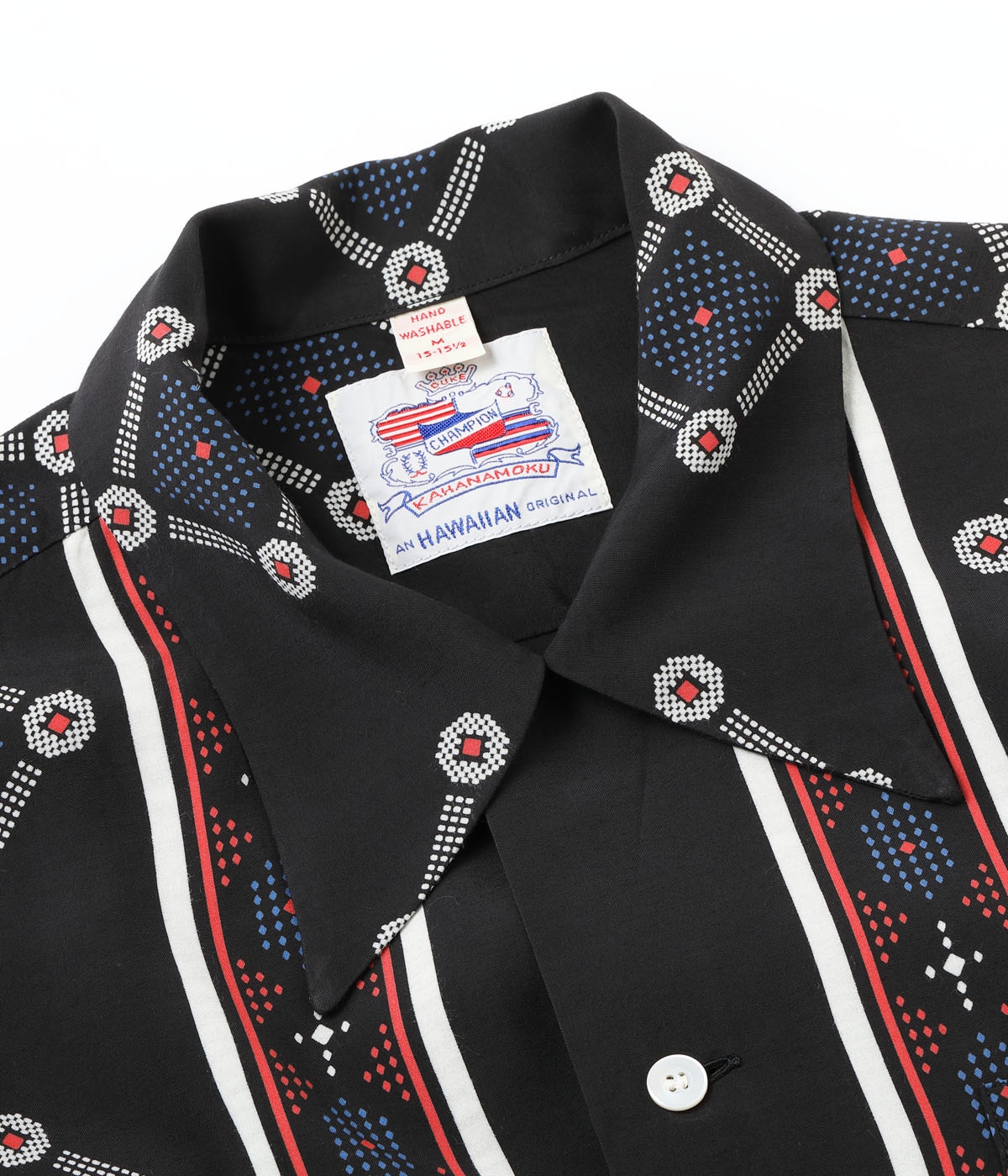 TITLE: “WESTCOAST PATTERN” ORIGINAL BRAND NAME: DUKE KAHANAMOKU ESTIMATED MANUFACTURING DATES: EARLY 1950s FABRIC: RAYON FUJIETTE PRINTING METHOD: DISCHARGE PRINTING PRINTING PATTERN: BORDER PATTERN BUTTON: WHITE SHELL BUTTON